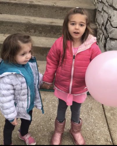 Lori's two daughters holding their balloon for Tiger.