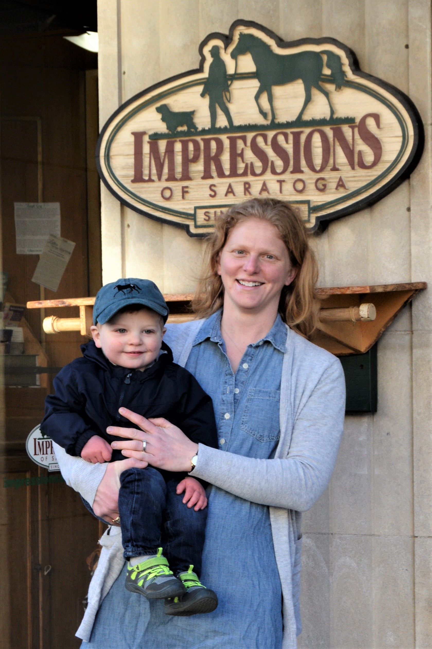 Author Maddy Zanetti with her son in front of her store, Impressions of Saratoga.