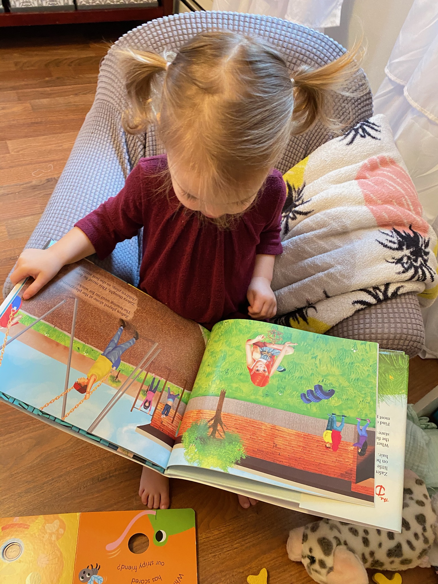A child reading one of Jodi Dee's award-winning books, The Dirt Girl!